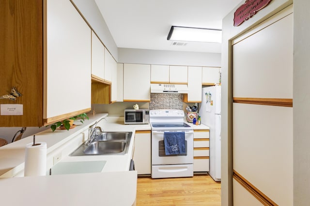 310 Westlake Ct Unit 310, Niceville, FL 32578 - kitchen featuring white appliances, premium range hood, white cabinets, and light countertops
