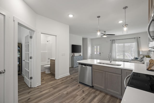 5862 Tyndall Pl, Panama City, FL 32404 - kitchen with dishwasher, open floor plan, wood finished floors, light countertops, and a ceiling fan