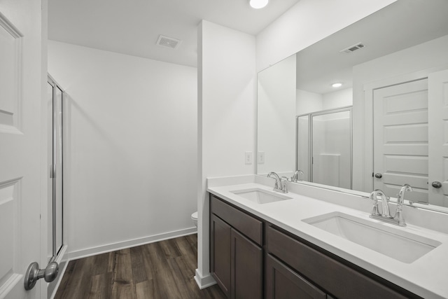 5862 Tyndall Pl, Panama City, FL 32404 - bathroom featuring a shower stall, wood finished floors, double vanity, and recessed lighting