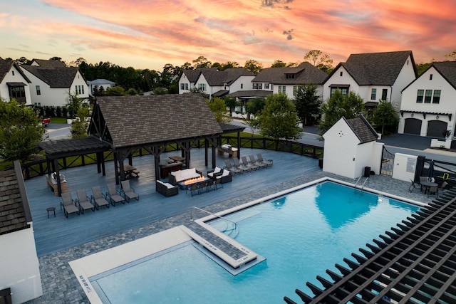 368 Ridgewalk Cir Lot 44B, Santa Rosa Beach, FL 32459 - pool at dusk with a gazebo, an outdoor hangout area, a community pool, and a residential view