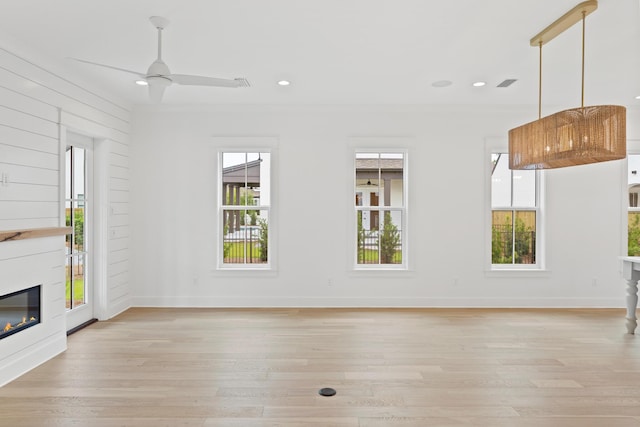368 Ridgewalk Cir Lot 44B, Santa Rosa Beach, FL 32459 - unfurnished living room featuring light wood-style flooring, a glass covered fireplace, ceiling fan, and recessed lighting