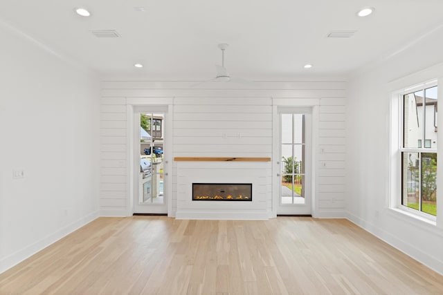 368 Ridgewalk Cir Lot 44B, Santa Rosa Beach, FL 32459 - unfurnished living room featuring light wood-style flooring, a glass covered fireplace, recessed lighting, and a ceiling fan