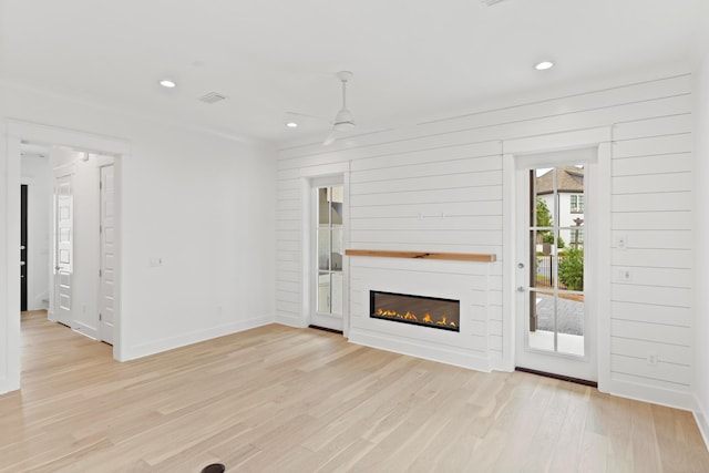 368 Ridgewalk Cir Lot 44B, Santa Rosa Beach, FL 32459 - unfurnished living room with ceiling fan, recessed lighting, light wood-type flooring, and a glass covered fireplace