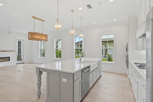 368 Ridgewalk Cir Lot 44B, Santa Rosa Beach, FL 32459 - kitchen with stainless steel appliances, gray cabinetry, light wood-style floors, light countertops, and an island with sink