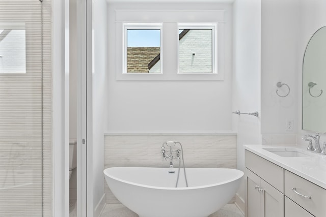 368 Ridgewalk Cir Lot 44B, Santa Rosa Beach, FL 32459 - full bathroom featuring vanity, wainscoting, a freestanding tub, and tile walls