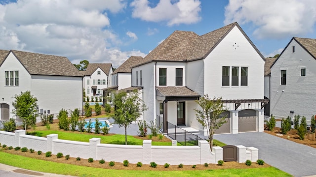 368 Ridgewalk Cir Lot 44B, Santa Rosa Beach, FL 32459 - view of front of house featuring a fenced front yard, an attached garage, asphalt driveway, a gate, and a residential view