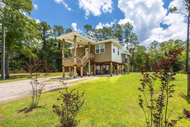 158 Johns Ln, Freeport, FL 32439 - rear view of house featuring stairs, a yard, a porch, and dirt driveway
