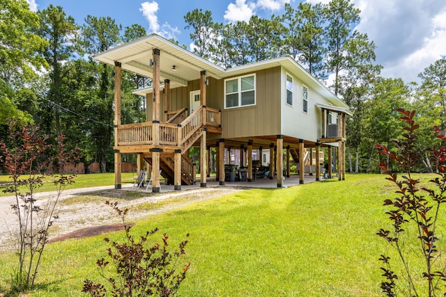 158 Johns Ln, Freeport, FL 32439 - rear view of property with stairway and a lawn