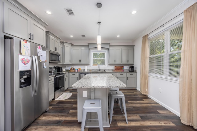 158 Johns Ln, Freeport, FL 32439 - kitchen with appliances with stainless steel finishes, gray cabinetry, crown molding, a center island, and a breakfast bar
