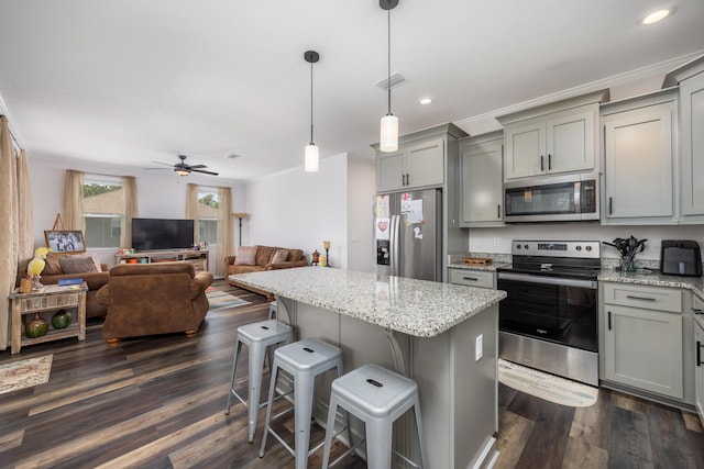 158 Johns Ln, Freeport, FL 32439 - kitchen featuring stainless steel appliances, gray cabinetry, a center island, a kitchen breakfast bar, and recessed lighting