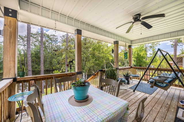 158 Johns Ln, Freeport, FL 32439 - deck featuring ceiling fan, view of scattered trees, and outdoor dining area