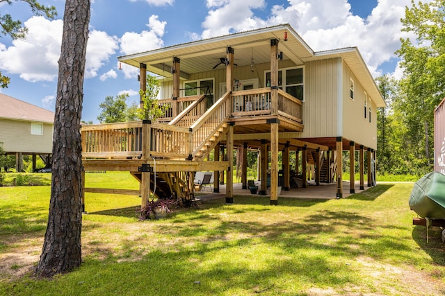 158 Johns Ln, Freeport, FL 32439 - back of property featuring stairway, a lawn, and a ceiling fan
