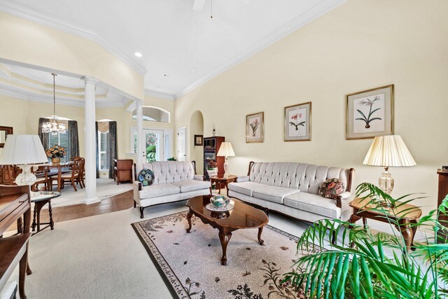 423 Maritime Ct, Destin, FL 32541 - living area featuring arched walkways, ornamental molding, decorative columns, a chandelier, and recessed lighting