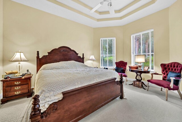 423 Maritime Ct, Destin, FL 32541 - carpeted bedroom featuring multiple windows, a raised ceiling, and ceiling fan