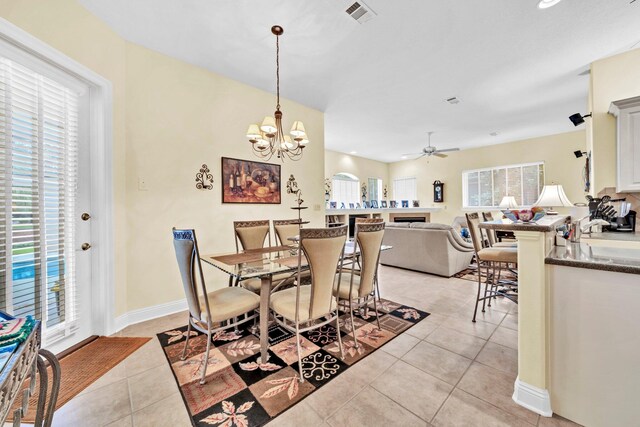 423 Maritime Ct, Destin, FL 32541 - dining area with light tile patterned floors, a chandelier, and ceiling fan