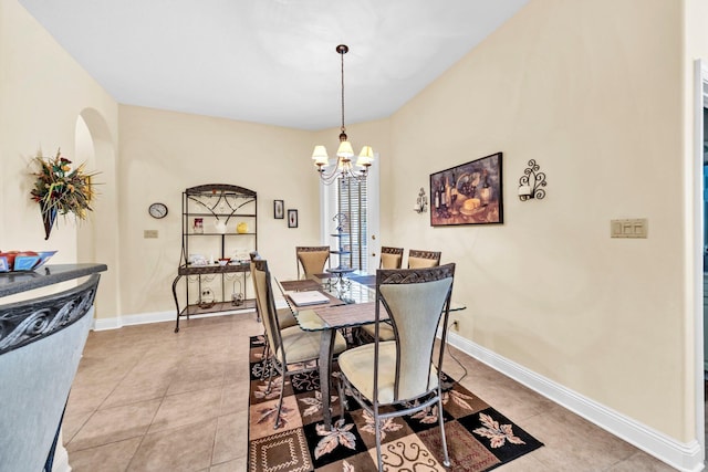 423 Maritime Ct, Destin, FL 32541 - dining space with arched walkways, light tile patterned flooring, and a chandelier