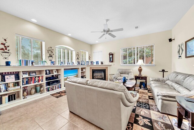 423 Maritime Ct, Destin, FL 32541 - living area with ceiling fan, light tile patterned flooring, a tile fireplace, and recessed lighting
