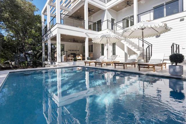 185 Dune Dr, Santa Rosa Beach, FL 32459 - swimming pool with ceiling fan, a patio area, stairway, and an outdoor hangout area