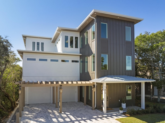 185 Dune Dr, Santa Rosa Beach, FL 32459 - contemporary house featuring board and batten siding, an attached garage, and driveway