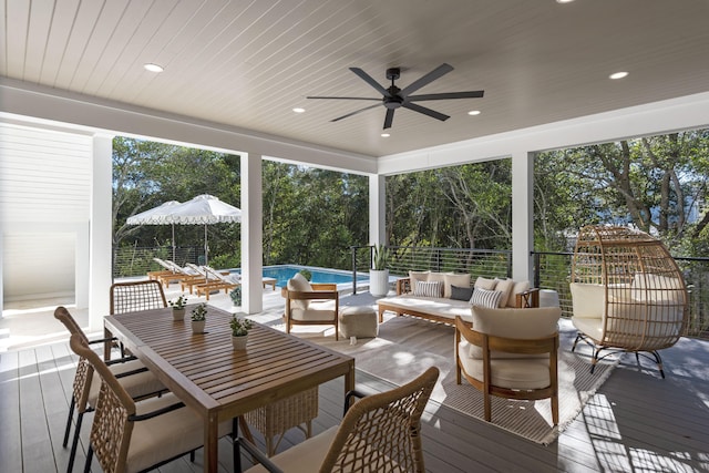185 Dune Dr, Santa Rosa Beach, FL 32459 - wooden deck with an outdoor living space, outdoor dining space, a ceiling fan, a patio area, and view of scattered trees