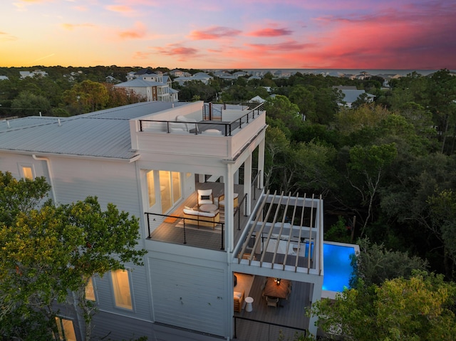 185 Dune Dr, Santa Rosa Beach, FL 32459 - back of property featuring a balcony, a metal roof, and an outdoor pool