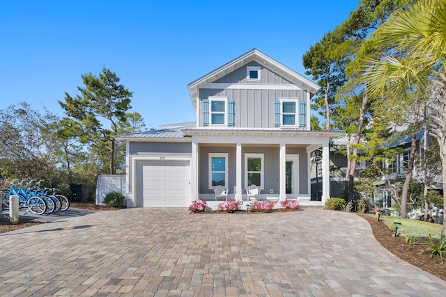 173 W Willow Mist Rd, Inlet Beach, FL 32461 - view of front of property featuring board and batten siding, a porch, decorative driveway, an attached garage, and a metal roof