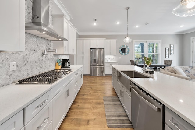 173 W Willow Mist Rd, Inlet Beach, FL 32461 - kitchen featuring wall chimney exhaust hood, stainless steel appliances, crown molding, decorative backsplash, and white cabinets