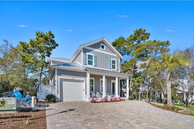 173 W Willow Mist Rd, Inlet Beach, FL 32461 - view of front facade featuring a porch, board and batten siding, a garage, decorative driveway, and a metal roof