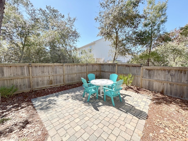 173 W Willow Mist Rd, Inlet Beach, FL 32461 - fenced backyard with a patio and outdoor dining area