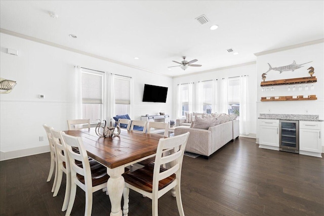 275 Gulfview Cir, Santa Rosa Beach, FL 32459 - dining room featuring beverage cooler, a dry bar, ornamental molding, dark wood finished floors, and ceiling fan