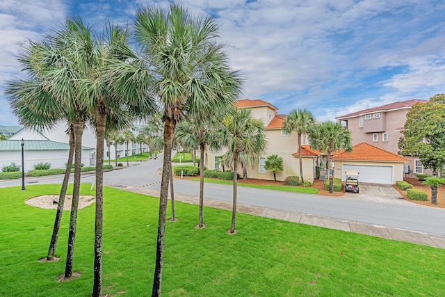 2606 Scenic Gulf Dr Unit 4206, Miramar Beach, FL 32550 - view of green lawn featuring concrete driveway and a residential view