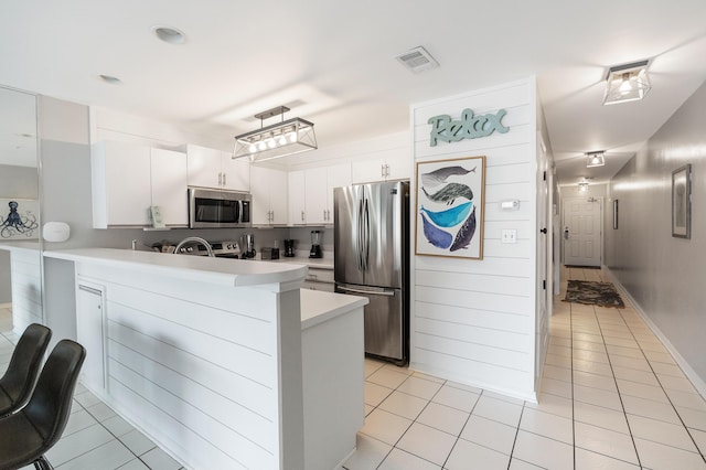 2606 Scenic Gulf Dr Unit 4206, Miramar Beach, FL 32550 - kitchen with stainless steel appliances, light tile patterned floors, a peninsula, and light countertops