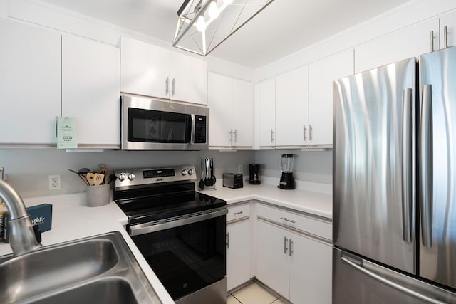 2606 Scenic Gulf Dr Unit 4206, Miramar Beach, FL 32550 - kitchen featuring appliances with stainless steel finishes, light countertops, and white cabinetry