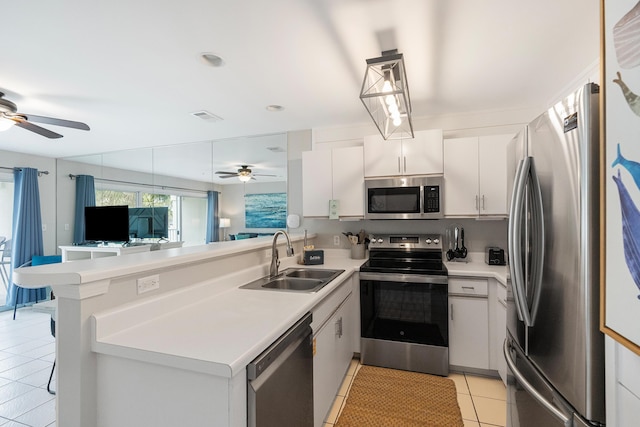 2606 Scenic Gulf Dr Unit 4206, Miramar Beach, FL 32550 - kitchen with stainless steel appliances, ceiling fan, light tile patterned floors, and a peninsula