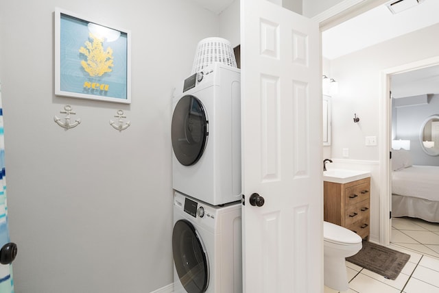 2606 Scenic Gulf Dr Unit 4206, Miramar Beach, FL 32550 - washroom featuring stacked washer / dryer and light tile patterned flooring
