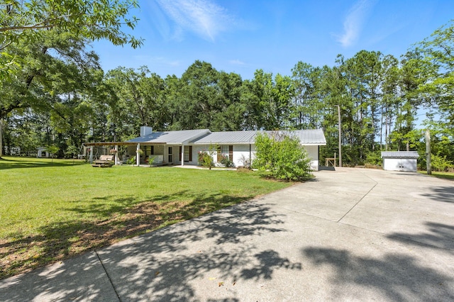 3774 Laird Rd, Crestview, FL 32539 - single story home with a front yard, a metal roof, a chimney, and concrete driveway