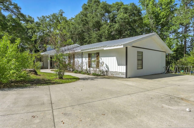 3774 Laird Rd, Crestview, FL 32539 - view of front of home featuring a metal roof, driveway, and stone siding