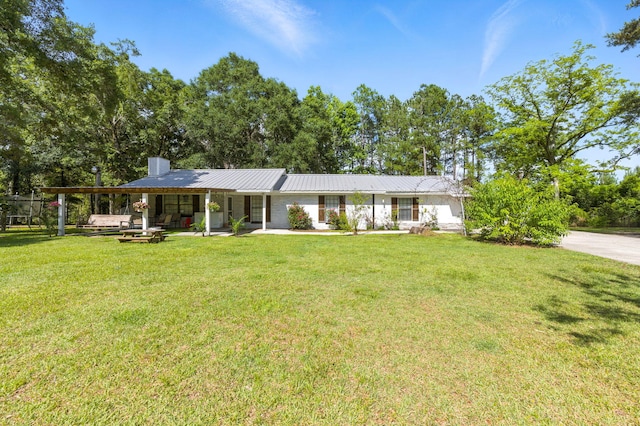 3774 Laird Rd, Crestview, FL 32539 - single story home featuring a front yard, a chimney, and a metal roof