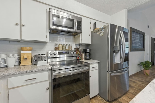 3774 Laird Rd, Crestview, FL 32539 - kitchen featuring appliances with stainless steel finishes, wood finished floors, backsplash, white cabinets, and a textured ceiling