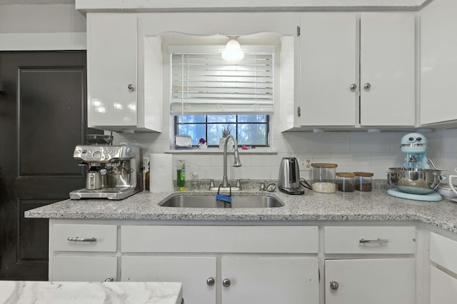 3774 Laird Rd, Crestview, FL 32539 - kitchen with white cabinets, backsplash, and light stone counters
