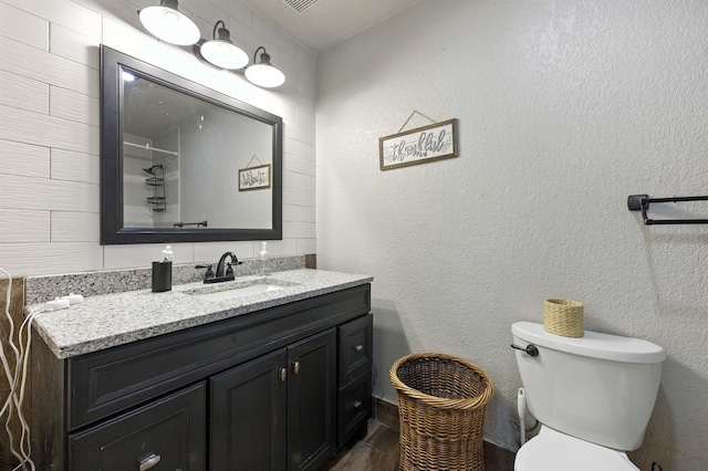 3774 Laird Rd, Crestview, FL 32539 - bathroom featuring vanity, wood finished floors, and a textured wall