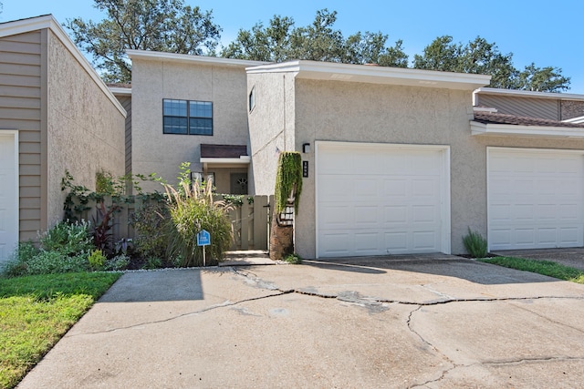 1090 5th Ave, Shalimar, FL 32579 - view of front of home featuring concrete driveway, stucco siding, and an attached garage
