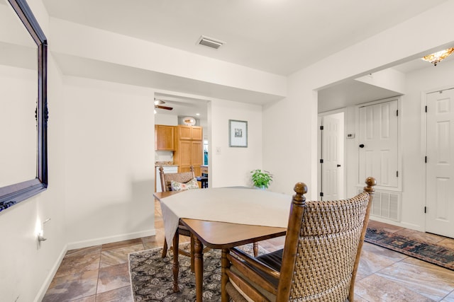 1090 5th Ave, Shalimar, FL 32579 - dining room featuring stone tile floors and a ceiling fan