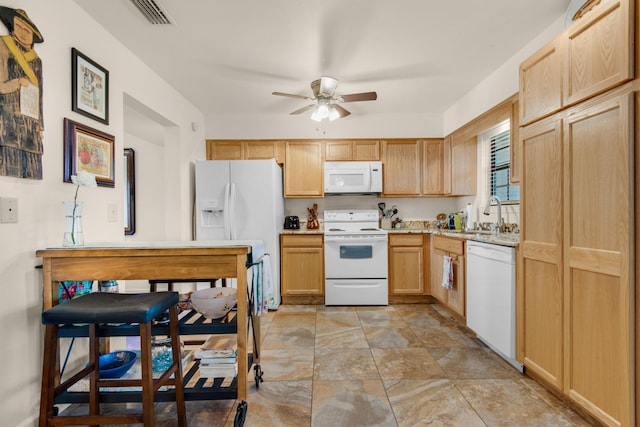 1090 5th Ave, Shalimar, FL 32579 - kitchen with white appliances, a ceiling fan, light countertops, light brown cabinets, and light stone finish flooring
