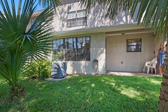 1090 5th Ave, Shalimar, FL 32579 - rear view of house featuring stucco siding and a lawn