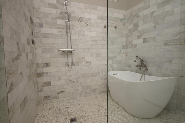 1262 Whitewood Way, Niceville, FL 32578 - bathroom featuring walk in shower, a freestanding bath, and tile walls