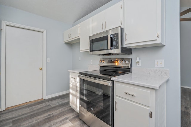504 Shortwell Ave, Crestview, FL 32539 - kitchen featuring appliances with stainless steel finishes, wood finished floors, and white cabinetry
