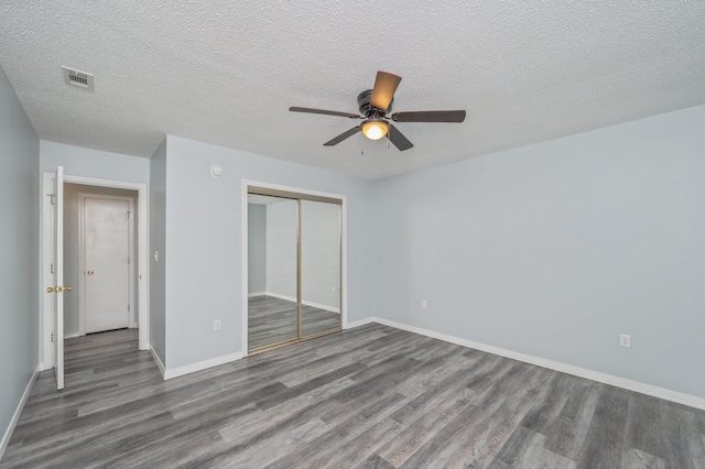 504 Shortwell Ave, Crestview, FL 32539 - unfurnished bedroom with wood finished floors, a closet, a textured ceiling, and ceiling fan