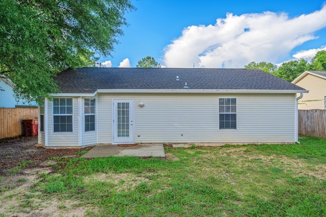 504 Shortwell Ave, Crestview, FL 32539 - back of house with a shingled roof and a patio area