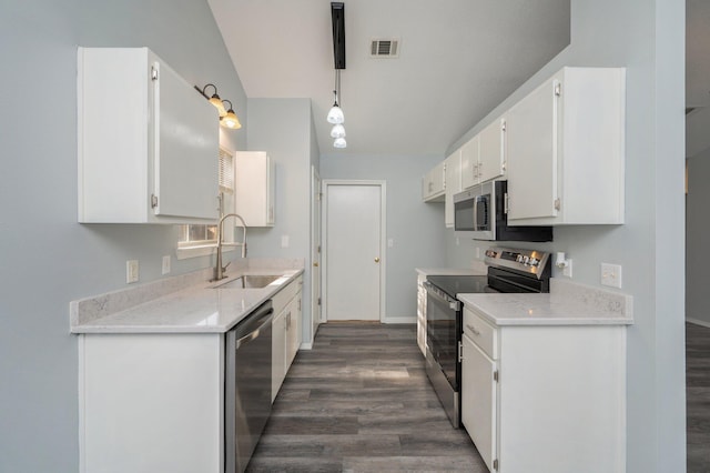 504 Shortwell Ave, Crestview, FL 32539 - kitchen with stainless steel appliances, dark wood finished floors, white cabinetry, and light countertops